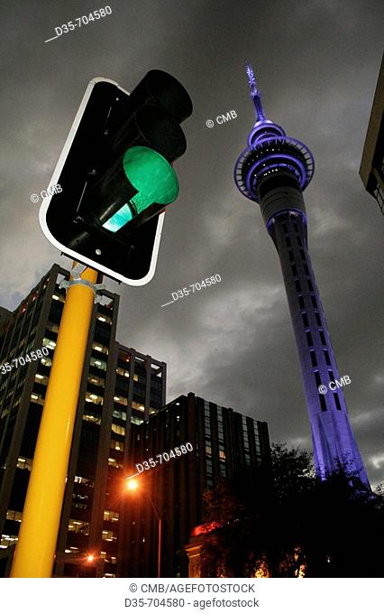 Traffic light and Skytower and dark sky in Auckland City, Auckland, North Island, New Zealand