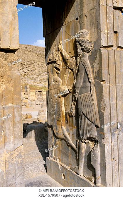 Bas-relief of a fighting warrior and lion at the archaeological site of Persepolis