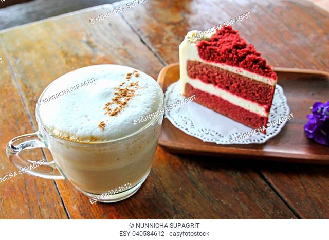 Cup of coffee and Red velvet cake on wooden table