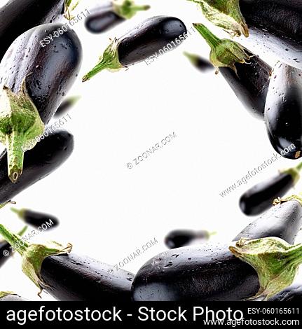 Ripe eggplants levitate on a white background