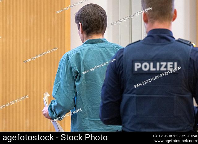 18 December 2023, Bavaria, Regensburg: The defendant stands in the courtroom of the regional court. For 20 years, the man lived as a subtenant in a...