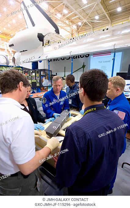 The STS-133 crew members participate in a training session in the Space Vehicle Mockup Facility at NASA's Johnson Space Center with instructor Alexandros...
