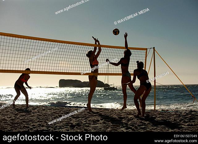 Female volleyball players playing on the beach