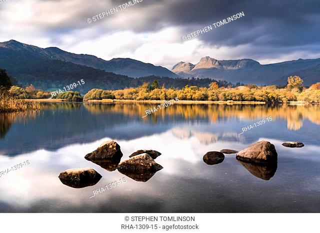 The Langdale Pikes reflected in the tranquil River Brathay, autumn, Elterwater, Lake District National Park, UNESCO World Heritage Site, Cumbria, England