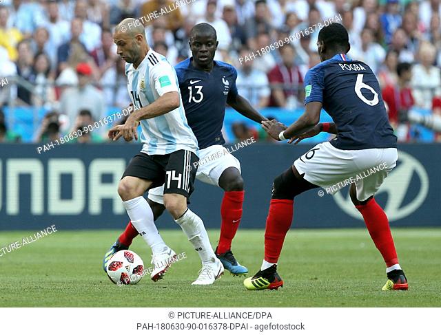 30 June 2018, Russia, Kazan: Football World Cup, France vs Argentina at the Kazan Arena. Javier Mascherano (l) of Argentina and N'Golo Kante (c) of France vie...