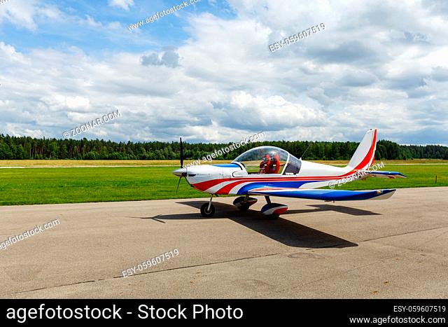 outdoor shot of small plane standing in meadow before take-off. summer season