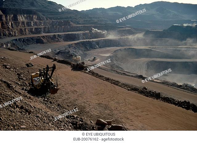 Iron mine. Machinery working on terraces