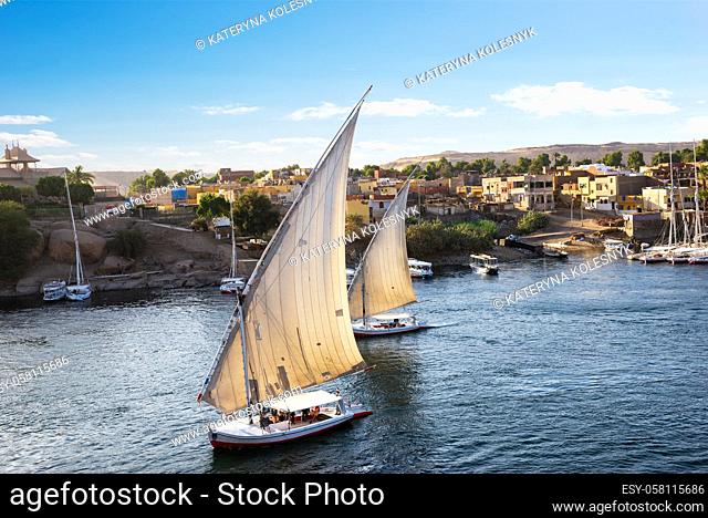 Sailboats in the waters of river Nile in Aswan at sunset, Egypt