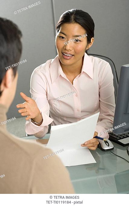 Businesswoman talking to co-worker