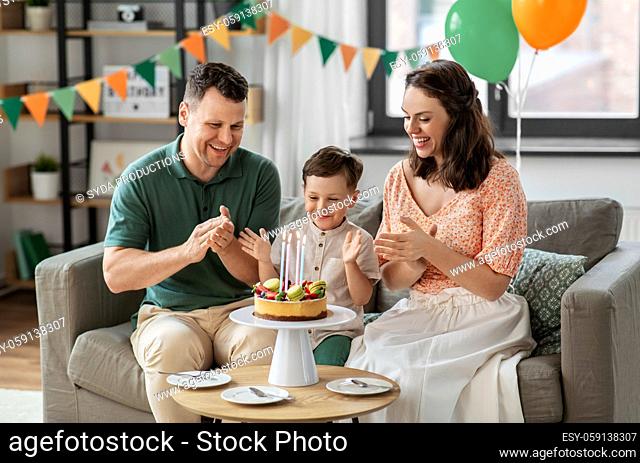 happy family with birthday cake at home