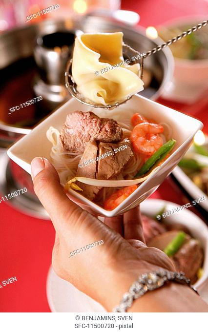 Food cooked in a pot-au-feu in a porcelain bowl