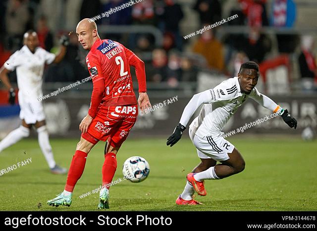 Kortrijk's Gilles Dewaele and Eupen's Konan Ignace N'Dri fight for the ball during a soccer match between KAS Eupen and KV Kortrijk