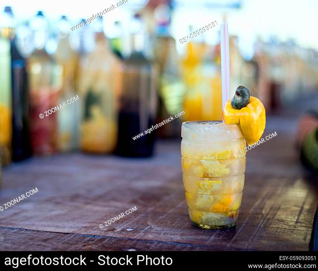 Caipirinha cocktail with Brazilian Caju Cashew fruit on the beach bar