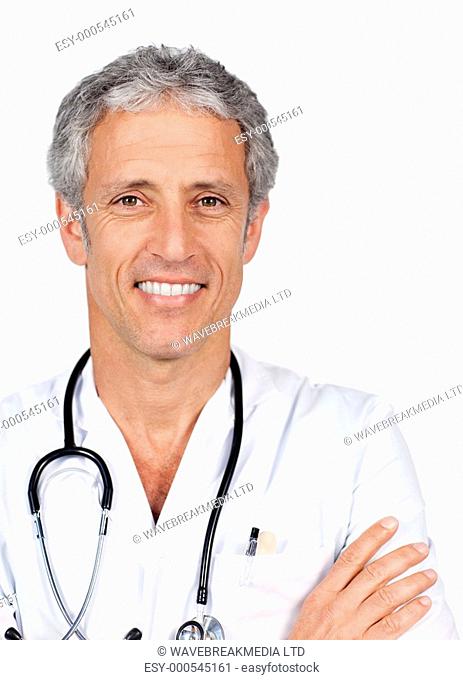 Mature doctor carrying a stethoscope against a white background
