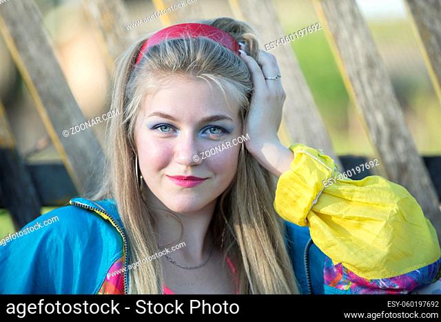 Beautiful country girl in 90s style with bright makeup and sports trowel