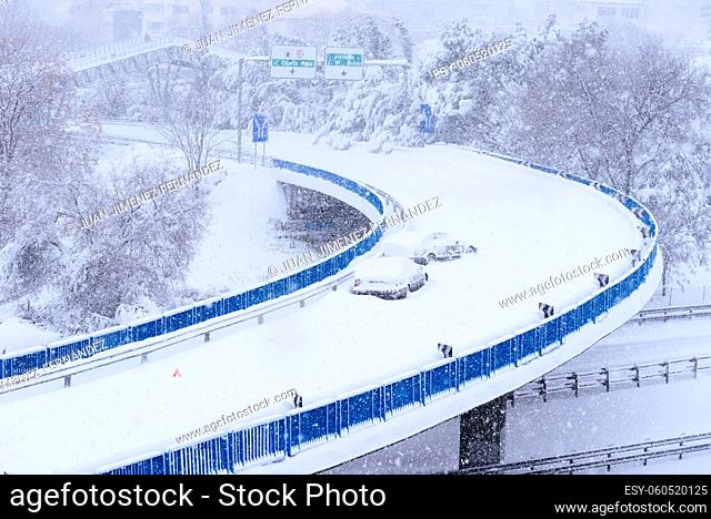 View of a highway in the city covered in snow during heavy snowfall with trapped vehicles. Storm Filomena in Madrid. M-30, Costa Rica area