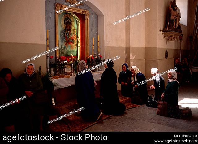 Church of San Francesco Saverio. Elderly ladies pray in front of a copy of the Image of Our Lady of Czestochowa. The church was used as a museum between 1960...