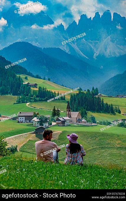 view of Santa Maddalena church in Dolomites, Italian Alps. Val Di Funes valley . Lonely church on green meadow on background of mountains