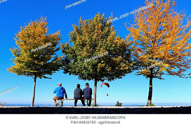 Excursionists enjoy the view from Buchenberg mountain underneath autumnal trees near Buching, Germany, 16 October 2016. PHOTO: KARL-JOSEF HILDENBRAND/dpa |...