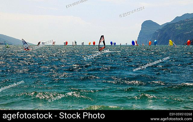 Sailing regatta with plenty of boats and beautiful colored sails. The competing sailing boats have windfilled sails and try to overtake each other