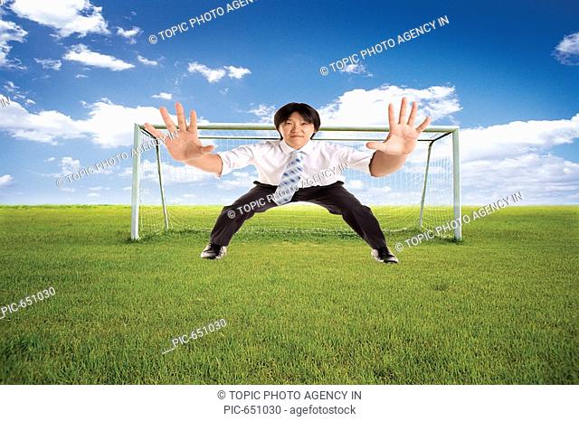 Korean Businessman Defensing at the Goal Post