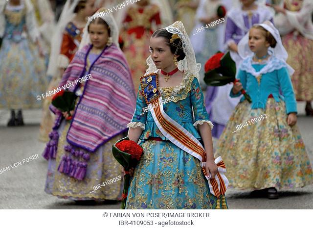 Fallas festival, girls in a traditional costume during the parade in the Plaza de la Virgen de los Desamparados, Valencia, Spain
