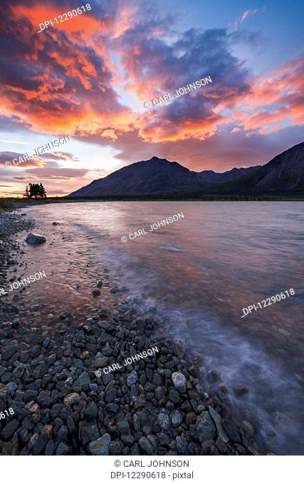 Colors of sunset fill the sky over upper Twin Lake in Lake Clark National Park & Preserve, Alaska