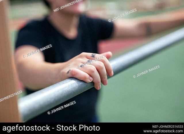 Young woman exercising at outdoor gym