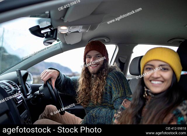 Portrait happy young couple inside car