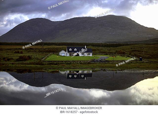 Water reflection of house, Connemara, County Galway, Republic of Ireland, Europe