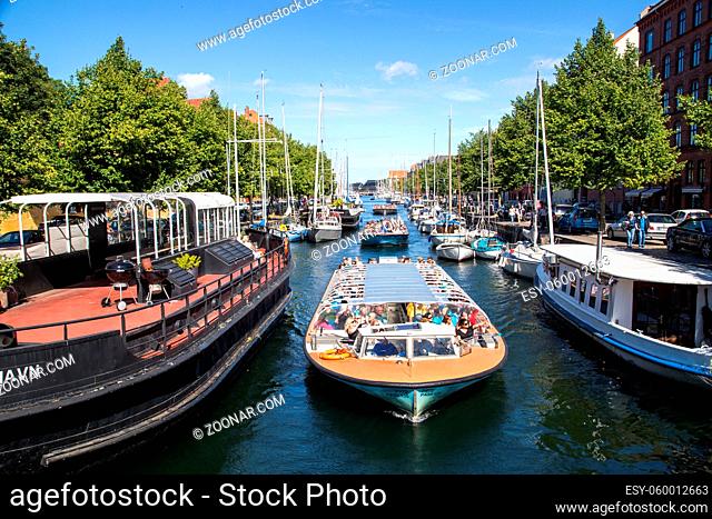 Copenhagen, Denmark - August 17, 2016: Tourist boats and sailboats in Christianshavn channel on a summer day