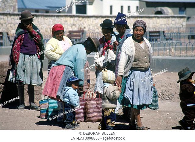 Salt pan, altiplano. Town. Women at bus stop