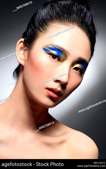 Blue and golden eye shadow beauty portrait