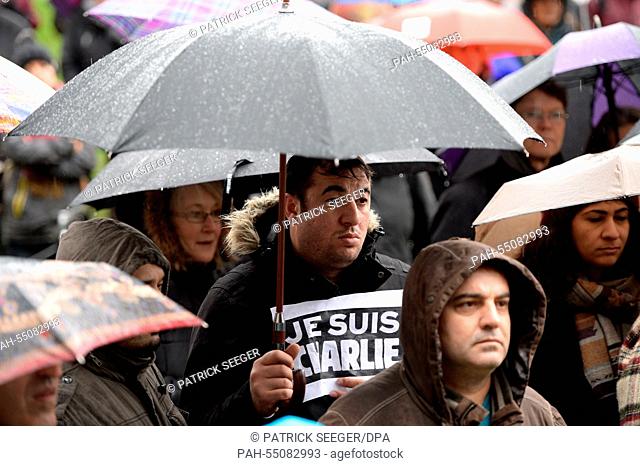 A man holds up a sign that reads 'Je suis Charlie' at a solidarity rally for 'Charlie Hebdo' in Freiburg, Germany, 17 January 2015