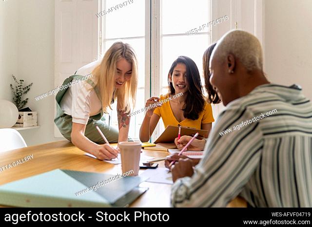 Businesswomen having a meeting and taking notes in office