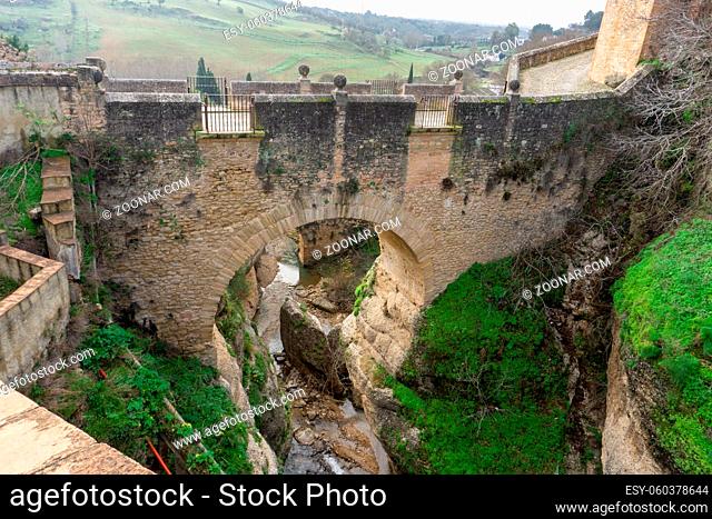 An old stone bridge in the El Tajo Gorge in Ronda in Andalusia