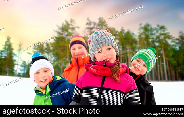 happy little children in winter clothes outdoors