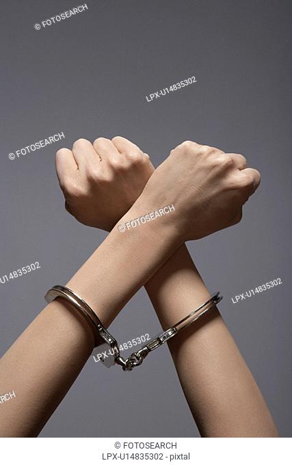 Woman's hands in handcuffs close-up