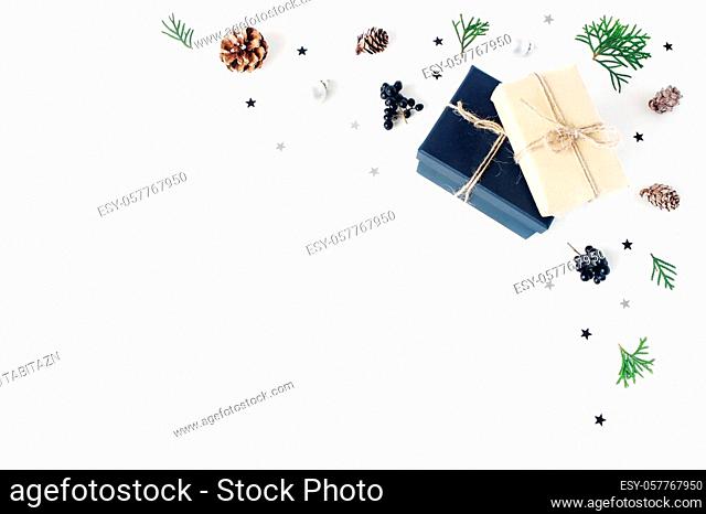 Christmas composition. Decorative corner, banner made of cypress branches, pine cones, christmas wrapped gifts, black berries and silver confetti stars