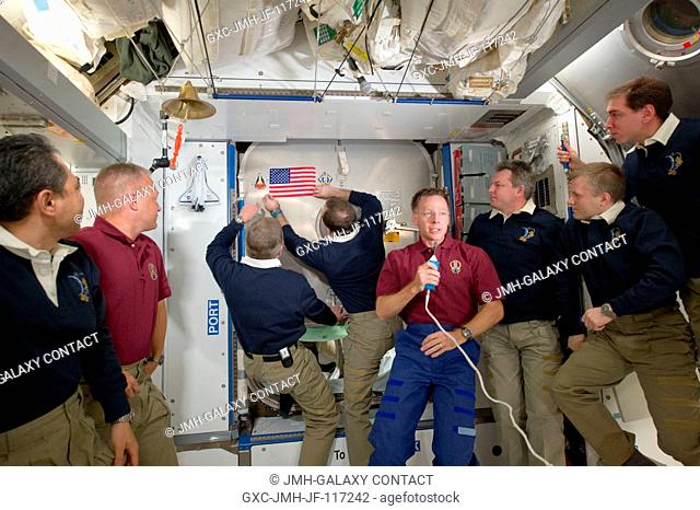At the farewell ceremony before the shuttle crew returned to Atlantis, NASA astronaut Chris Ferguson (center with microphone), STS-135 commander