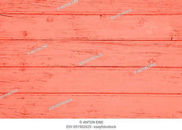 Close up background texture of coral pink color toned vintage painted wooden planks, rustic style wall panel