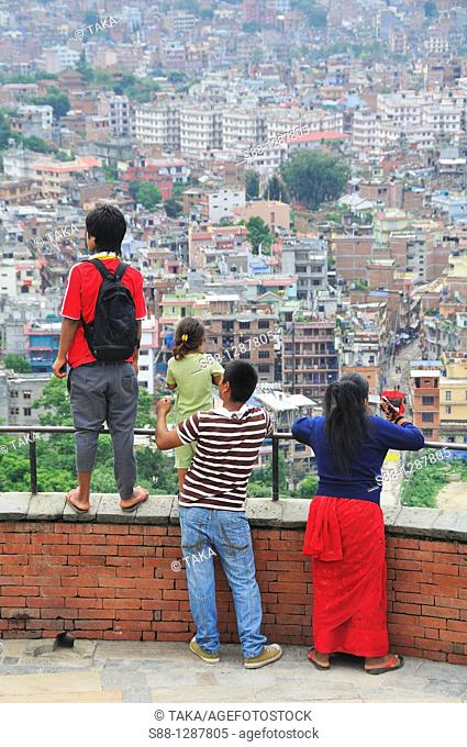 Family looking at Kathmandu city from Swayambhunath temple, Nepal