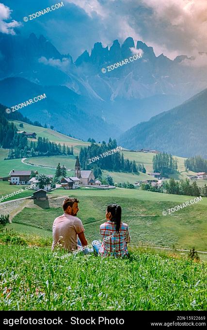 couple on vacation in the Dolomites Italy, Santa Magdalena Village in Dolomites area Italy Europe Val Di Funes