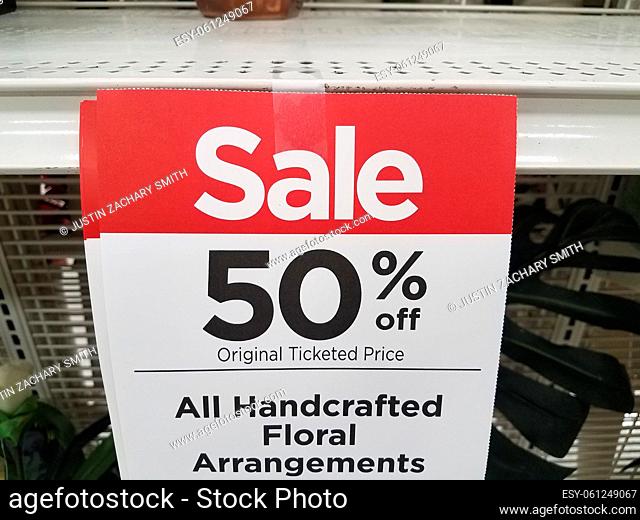 a fifty percent off handcrafted floral arrangements sign
