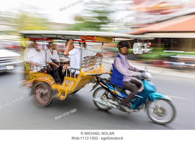 Motion blur image of a tuk-tuk in the capital city of Phnom Penh, Cambodia, Indochina, Southeast Asia, Asia