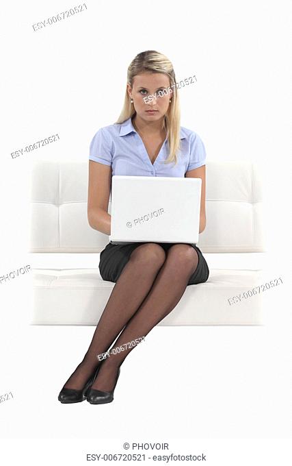 Austere woman typing on her laptop