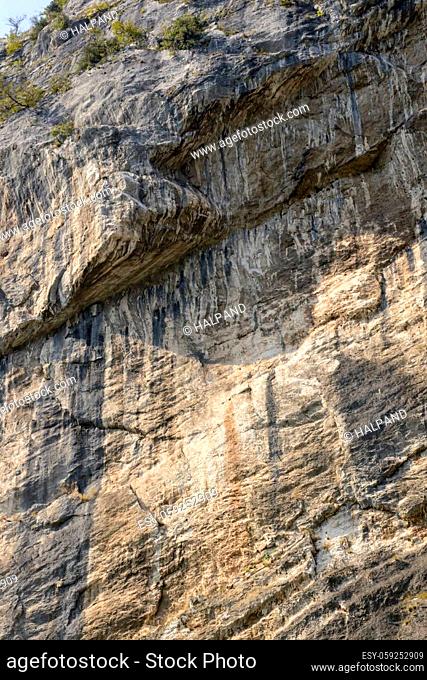 detail of vertical cliff, shot in bright fall light near Arco, Trento, Italy