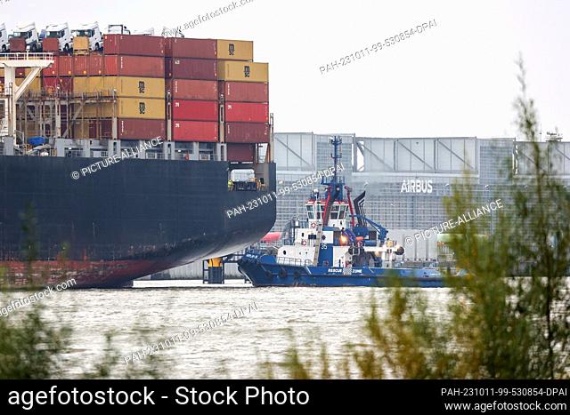 11 October 2023, Hamburg: The container ship ""MSC Regulus"" is moored on the Elbe River near the Airbus plant in Finkenwerder