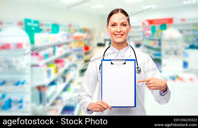 happy female doctor with clipboard at pharmacy
