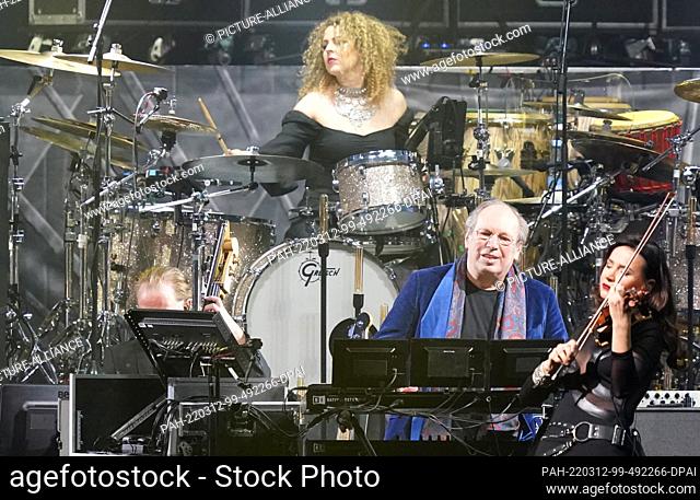 11 March 2022, Hamburg: German film composer Hans Zimmer (2nd from right) performs on stage at Barclays Arena together with his musicians and the Odessa...